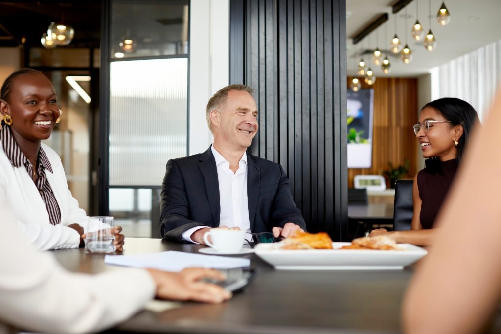 Proctor Major staff having a meeting at a table