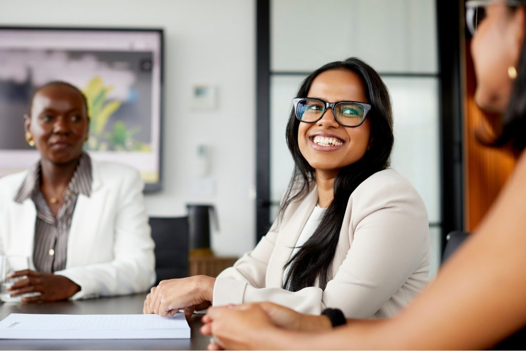 woman smiling at a desk